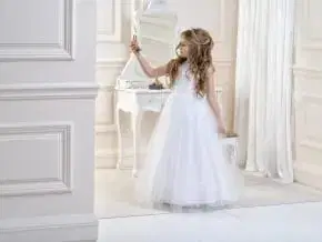 Girl in elegant white gown near vanity