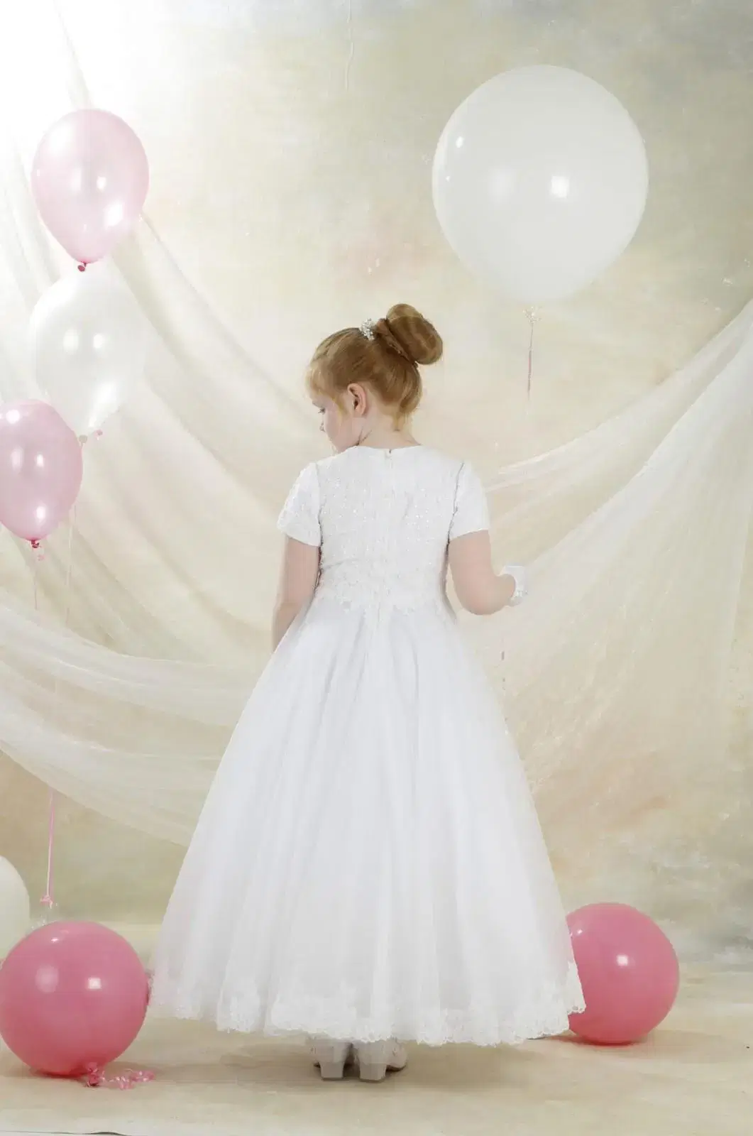 Girl with balloons in white dress