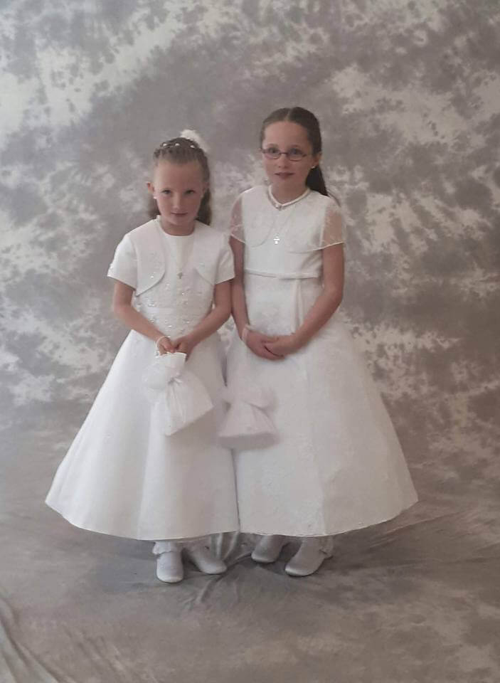 2 girls with their communion dresses