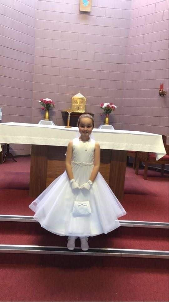 girl wearing white dress in church
